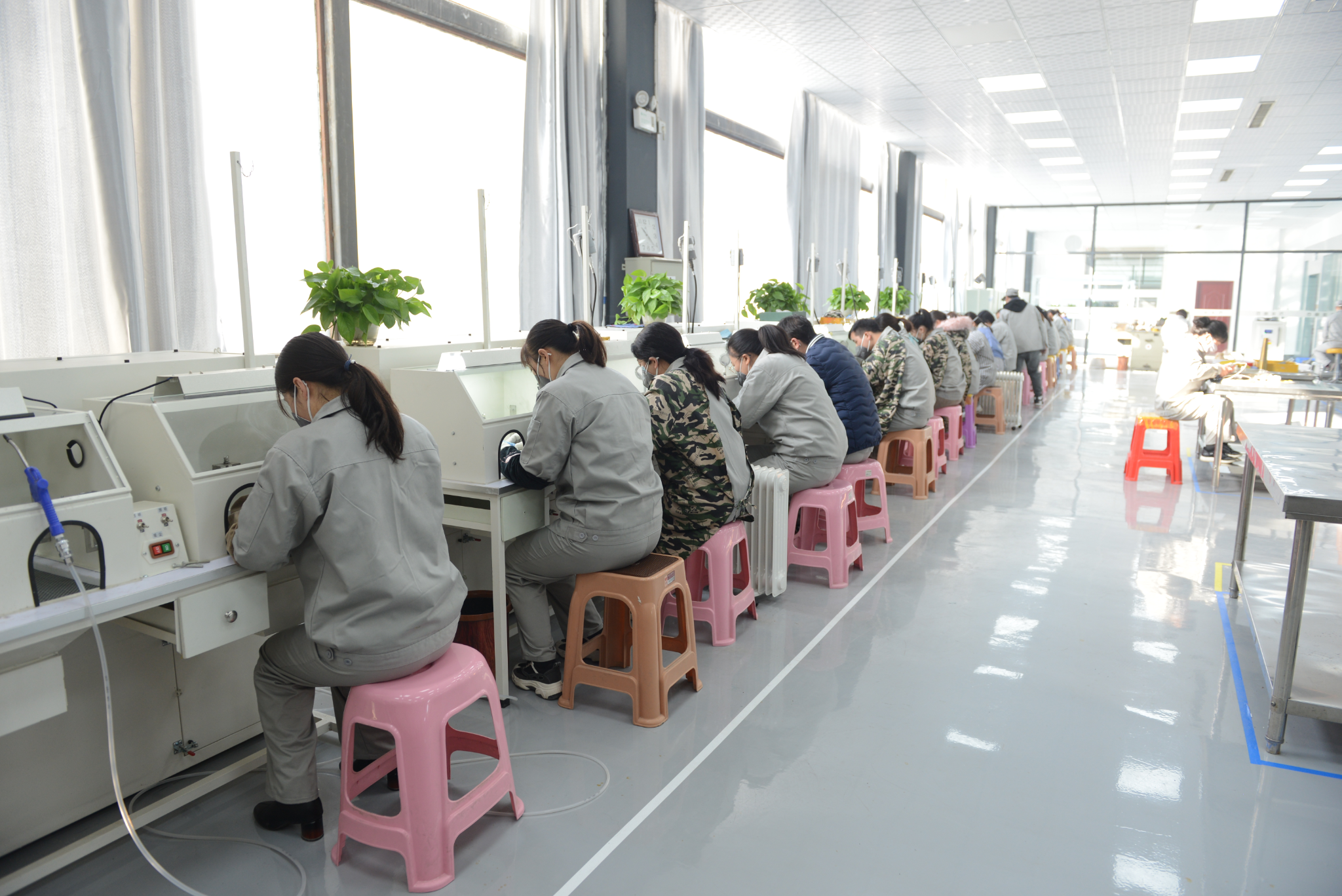 Jewelry production floor with workers at individual benches
